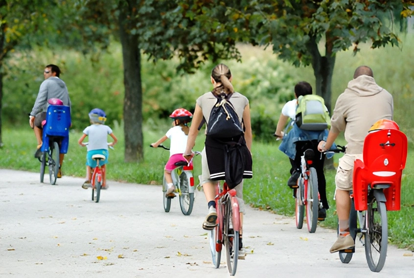 family and friends riding rented bikes on a country road