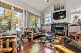 Interior view of main living area with rustic furnishings and fireplace