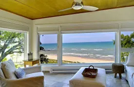 View of Lake Michigan through large picture window of modern home lakefront home