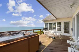 Home with outdoor deck and hot tub overlooking Lake Michigan